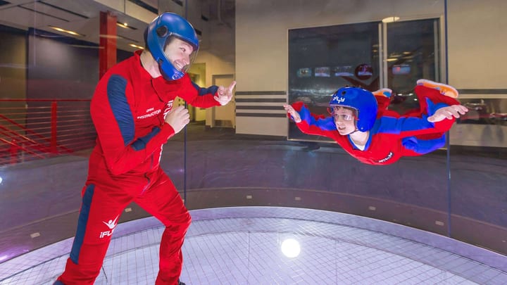 A kid and a grown up flying at iFLY